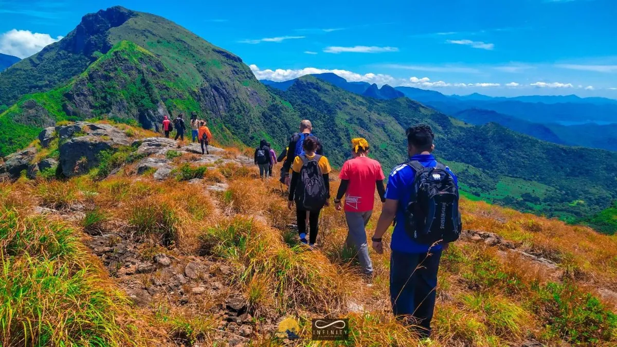 A group of hikers walking a forest trail in the Knuckles