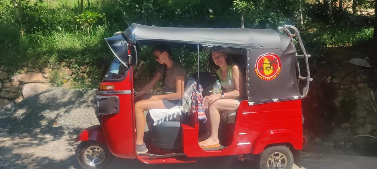 A tuk-tuk on the estate road with guests arriving